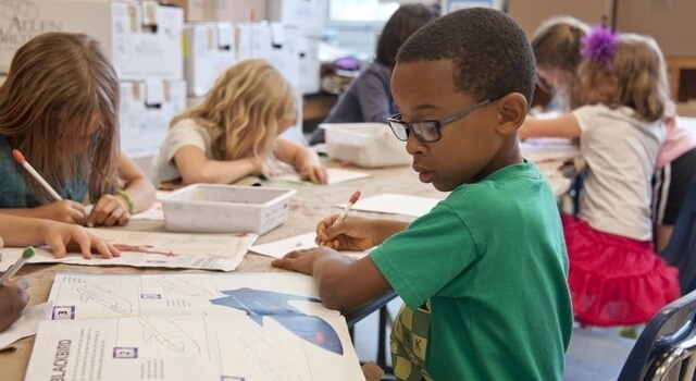 boy wearing eyeglasses studying 640×350